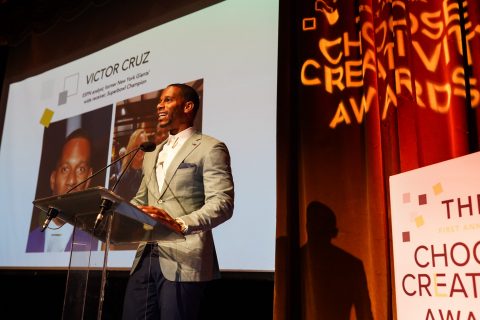 Football star Victor Cruz presenting the Authentic Leadership award to Kristin Lemkau